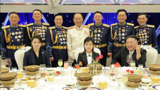 Kim Jong Un and family taking a group picture with high ranking military officials.