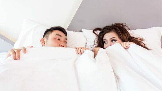 How to practise self care in a relationship - couple lying in bed